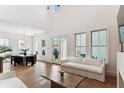 Bright and airy living room with hardwood floors, large windows, and access to the backyard at 1474 Blue Cascade Dr, Mount Pleasant, SC 29464