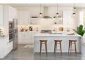 Bright kitchen features white cabinets, stainless appliances, a large island, and pendant lighting at 2042 Mcguire Ln # 011, Hollywood, SC 29449