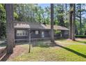 Charming home with a covered porch, brick foundation, and lush green lawn at 205 Woodlawn St, Walterboro, SC 29488