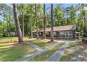 A beautiful view of the exterior of this home, surrounded by large trees and greenery at 205 Woodlawn St, Walterboro, SC 29488