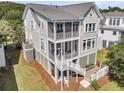 Stunning coastal home with multiple screened porches and charming architectural details at 2072 Amenity Park Dr, Mount Pleasant, SC 29466