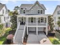 Beautiful home with a spacious front porch, grand staircase, and two-car garage at 2072 Amenity Park Dr, Mount Pleasant, SC 29466