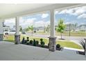 View from the covered porch showing the neighborhood with well-manicured lawns at 209 Country Gate Ln, Summerville, SC 29485