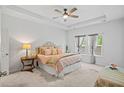 Bright main bedroom with a tray ceiling, large windows, and stylish decor at 209 Country Gate Ln, Summerville, SC 29485