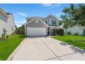 Charming two-story home with a spacious driveway, well-maintained lawn, and attached two-car garage at 216 Goldfinch Ln, Summerville, SC 29485