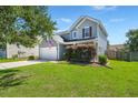 Beautiful two-story house with a well-kept lawn, attractive landscaping, and an American flag display at 216 Goldfinch Ln, Summerville, SC 29485