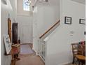 Bright foyer featuring tile flooring, a staircase, and a high ceiling with a window, creating an open entrance at 216 Goldfinch Ln, Summerville, SC 29485