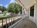 Covered front porch with white railings, planter boxes, and views of the surrounding neighborhood and mature trees at 2173 Annie Laura Ln, Mount Pleasant, SC 29466