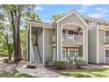 Eye-level exterior of a condo building, with stairs, well-kept bushes, and walkways at 2317 Tall Sail Dr # 1005, Charleston, SC 29414