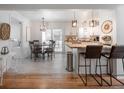 Open kitchen and dining area with pendant lighting, hardwood floors, and modern design at 2515 Violet Ave, North Charleston, SC 29405