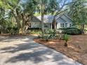 Inviting single-story home with well-manicured landscaping, a curved driveway, and plenty of curb appeal at 2655 Gnarled Pine, Seabrook Island, SC 29455
