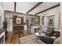 Open-concept living room with exposed wooden beams, wood accents, and modern decor is an inviting space at 2963 Alabama Dr, North Charleston, SC 29405