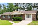 Charming brick home featuring a manicured lawn, brickwork and well-kept landscaping at 305 Forest Cir, Summerville, SC 29483