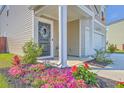 Charming front porch with flowerbeds, neutral siding, and a view of the garage and front yard at 307 Fox Gap Rd, Summerville, SC 29486