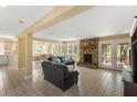 Inviting living space with stone fireplace, tile flooring, and abundant natural light at 33 Painted Bunting Ln, Kiawah Island, SC 29455