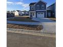 Charming two-story home with blue siding, white trim, a one-car garage, and a concrete driveway at 352 Chapman Cir, Goose Creek, SC 29445