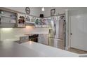 Bright kitchen with stainless steel appliances, white countertops, and colorful cabinet art at 359 Muirfield Pkwy, Charleston, SC 29414