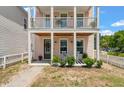 Inviting front porch with rocking chairs, perfect for relaxing and enjoying the neighborhood views at 4631 Scout Aly, North Charleston, SC 29405