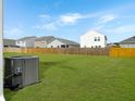 Expansive backyard featuring a well-maintained lawn and a privacy fence for outdoor enjoyment at 5003 Ferry Field Dr, Summerville, SC 29485