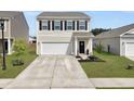 Charming two-story home with a well-manicured lawn and a two-car garage and inviting entrance at 5003 Ferry Field Dr, Summerville, SC 29485
