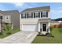 Charming two-story home with a well-manicured lawn and a two-car garage and inviting entrance at 5003 Ferry Field Dr, Summerville, SC 29485