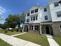 Charming two-story townhome featuring brick accents, black shutters, and a well-manicured lawn at 5100 Double Eagle, Summerville, SC 29485