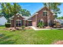 All brick home with tidy lawn and mature landscaping, including palm trees and green shutters at 569 Pointe Of Oaks Rd, Summerville, SC 29485
