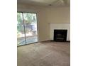 Cozy living area with a fireplace and sliding glass doors to the backyard at 6 Town Park Ln # C, Charleston, SC 29412