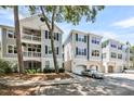 Attractive gray condos featuring private garages, covered patios, and manicured landscaping at 60 Fenwick Hall Aly # 415, Johns Island, SC 29455