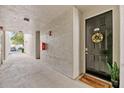 Inviting condo entrance with a welcome mat and a charming wreath on the front door at 60 Fenwick Hall Aly # 415, Johns Island, SC 29455