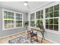 Bright office with large windows, wood floors, and a stylish desk setup at 60 Fenwick Hall Aly # 415, Johns Island, SC 29455