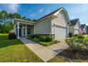 Attractive one-story home featuring a covered entrance, two-car garage, and landscaped front yard at 626 Battery Edge Dr, Summerville, SC 29486