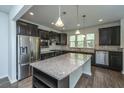 Well-lit kitchen features stainless steel appliances, granite counters, and center island at 626 Battery Edge Dr, Summerville, SC 29486