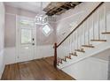 Inviting foyer featuring a staircase, hardwood floors, and natural light at 634 Rutledge Ave, Charleston, SC 29403