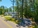Suburban home with a large yard and mature trees at 689 W Butternut Rd, Summerville, SC 29483