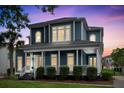 Charming two-story home boasts a spacious front porch, manicured landscaping, and classic architectural details at 6910 Tanner Hall Blvd, Hanahan, SC 29410