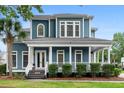 Charming two-story home boasts a spacious front porch, manicured landscaping, and classic architectural details at 6910 Tanner Hall Blvd, Hanahan, SC 29410