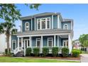 Charming two-story home boasts a spacious front porch, manicured landscaping, and classic architectural details at 6910 Tanner Hall Blvd, Hanahan, SC 29410