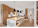 A bright and spacious kitchen with a large center island, modern pendant lighting, and stainless steel appliances at 71 Moultrie St, Charleston, SC 29403