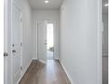Bright hallway features wood flooring, white walls, and an open door with natural light streaming in at 740 Meadowbrook Lane, Summerville, SC 29486