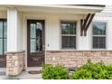 Inviting front door with glass panels and stone accents provide an attractive entrance to the townhome at 7812 Park Gate Dr, North Charleston, SC 29418