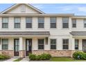 Exterior view of townhome with white siding, stone accents and covered entryways, reflecting modern design at 7812 Park Gate Dr, North Charleston, SC 29418