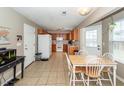 An open floor plan kitchen and dining area with tile floors and neutral colored walls at 102 Jasimine Ct, Summerville, SC 29486