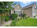 Landscaped garden bed with mature shrubbery along the side of the home at 105 Corral Cir, Summerville, SC 29485