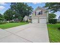 View of the home's two car garage and long driveway at 105 Corral Cir, Summerville, SC 29485