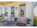 Charming front porch featuring rocking chairs and potted plants, highlighting a welcoming entrance at 112 Crimson St, Summerville, SC 29486