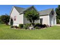 Well-manicured lawn with landscaping and flowering plants surrounding a charming house at 114 Sea Cotton Cir, Charleston, SC 29412