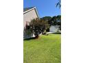 A well-kept lawn and mature trees surround the exterior of this house at 114 Sea Cotton Cir, Charleston, SC 29412