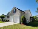 Charming home with a two-car garage, neutral siding, and well-maintained landscaping at 114 Sea Cotton Cir, Charleston, SC 29412