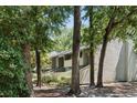 Exterior view of a two-story condo nestled among mature trees, creating a tranquil and private ambiance at 1195 Village Creek Ln # 2, Mount Pleasant, SC 29464